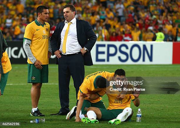 Australian coach Ange Postecoglou, Tim Cahill of Australia and Massimo Luongo of Australia look on after the 2015 Asian Cup final match between Korea...