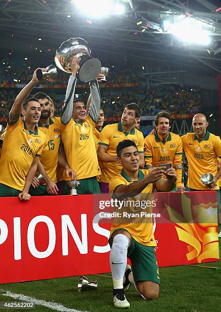 Massimo Luongo of Australia talkes a selfie as Australia celebrate during the 2015 Asian Cup final match between Korea Republic and the Australian...