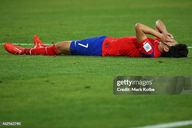 Son Heung Min of Korea Republic lies on the ground dejected after defeat during the 2015 Asian Cup final match between Korea Republic and the...