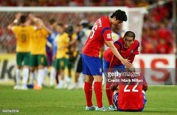 Ki Sung Yueng, Kim Ju Young and Cha Du Ri of Korea Republic look dejected after losing the 2015 Asian Cup final match between Korea Republic and the...