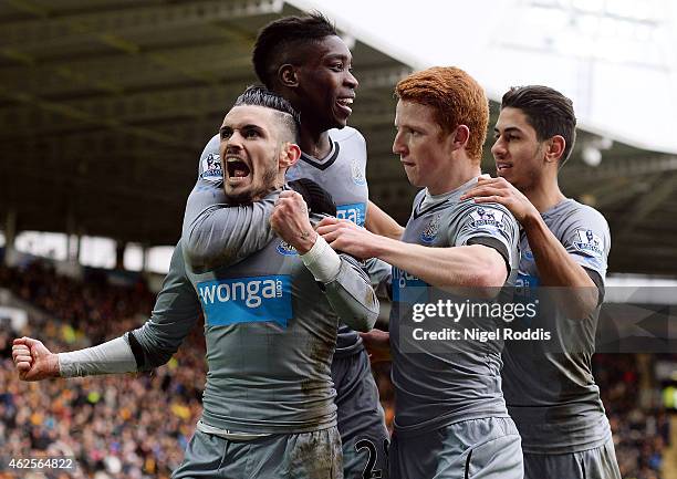 Remy Cabella of Newcastle United celebrates scoring the opening goal with team mates during the Barclays Premier League match between Hull City and...