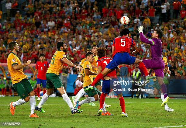 Mathew Ryan of Australia makes a save during injury time of extra time during the 2015 Asian Cup final match between Korea Republic and the...