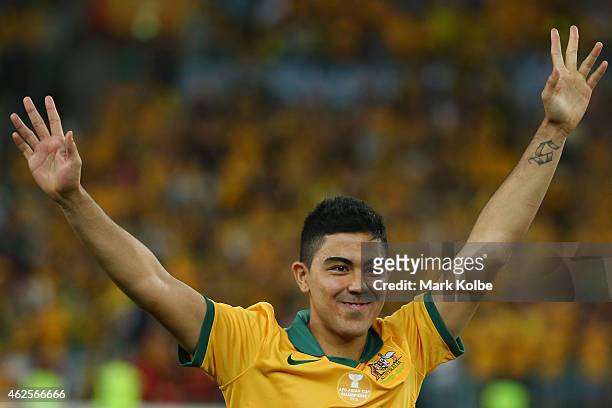 Massimo Luongo of Australia waves to the crowd as he walks to the stage to receieve the most valuable player at the 2015 Asian Cup award during the...
