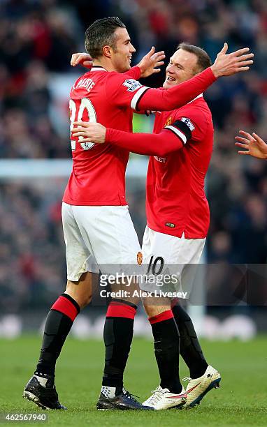 Robin van Persie of Manchester United is congratulated by teammate Wayne Rooney after scoring his team's first goal during the Barclays Premier...