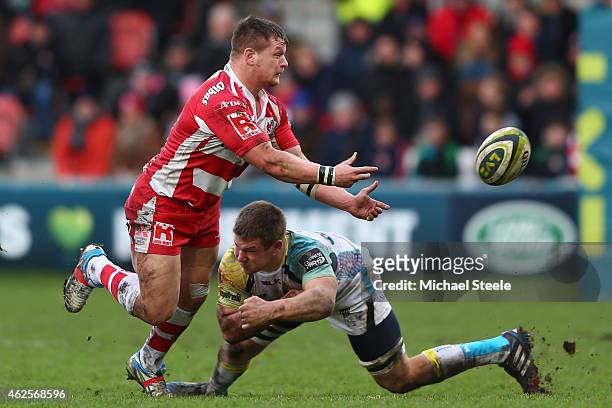Darren Dawidiuk of Gloucester passes as Olly Cracknell of Ospreys holds on during the LV=Cup match between Gloucester Rugby and Ospreys at Kingsholm...