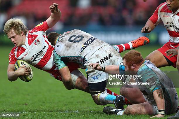 Dan Thomas of Gloucester is tackled by Olly Cracknell of Ospreys during the LV=Cup match between Gloucester Rugby and Ospreys at Kingsholm Stadium on...