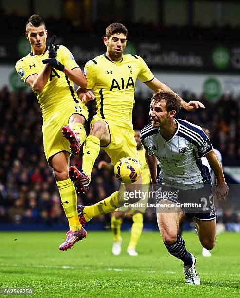 Erik Lamela of Spurs and Federico Fazio of Spurs block Craig Dawson of West Brom during the Barclays Premier League match between West Bromwich...