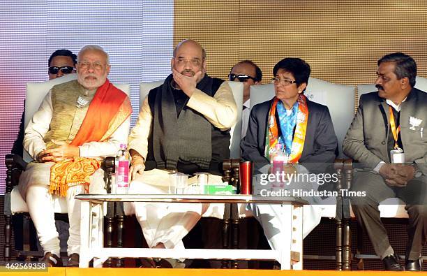 Prime Minister Narendra Modi with party's chief Ministerial candidate Kiran Bedi, BJP president Amit Shah and Delhi BJP president Satish Upadhayay...