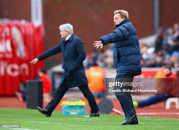 Manager Mark Hughes of Stoke City and Harry Redknapp the QPR manager on the touchline during the Barclays Premier League match between Stoke City and...