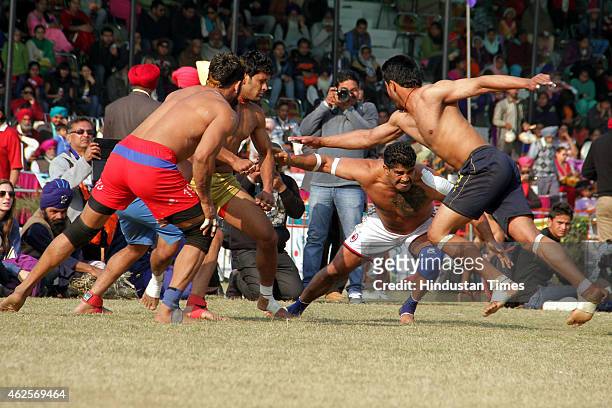 Players in action during a Kabaddi match at 79th Kila Raipur rural sports festival at village Kila Raipur on January 29, 2015 in Ludhiana, India....