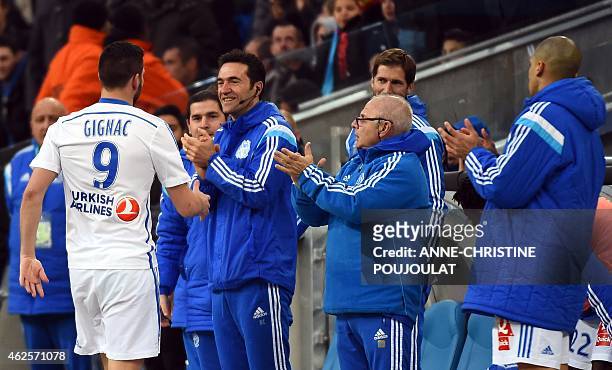 Marseille's French forward Andre-Pierre Gignac is congratulated after scoring a goal during the French L1 football match between Marseille and Evian...