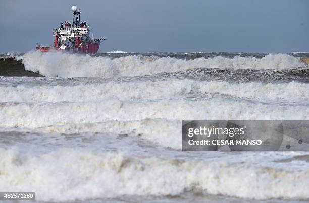 Boat leaves the port of Santander as strong wind blows, on January 31, 2015. Fierce waves were pounding seafronts and fishing boats off northern...