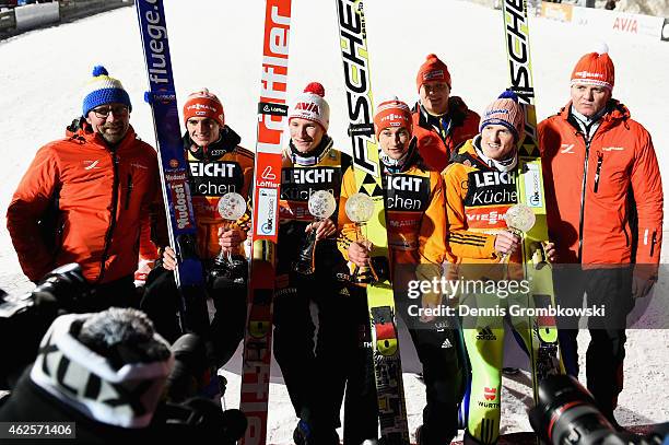 German ski jumpers Markus Eisenbichler, Marinus Kraus, Richard Freitag and Severin Freund pose after finishing second in the Large Hill Team...