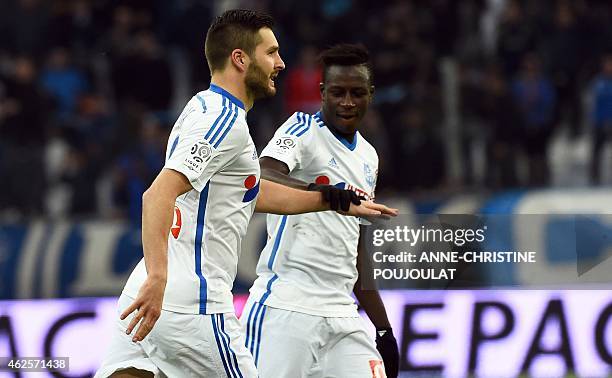 Marseille's French forward Andre-Pierre Gignac is congratulated by Marseille's French defender Benjamin Mendy after scoring a goal during the French...