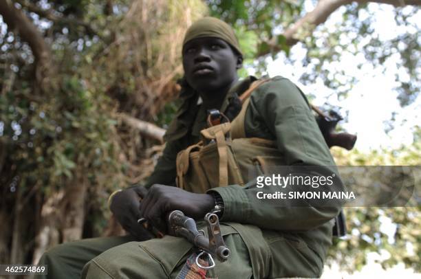 Member of South Sudan's army, Sudan People's Liberation Army , sits outside the governor's compound in Malakal, the capital of the biggest oil...