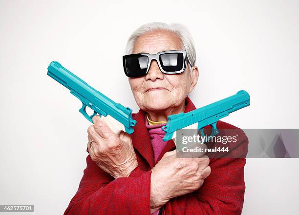 grandmother - toy gun stock pictures, royalty-free photos & images