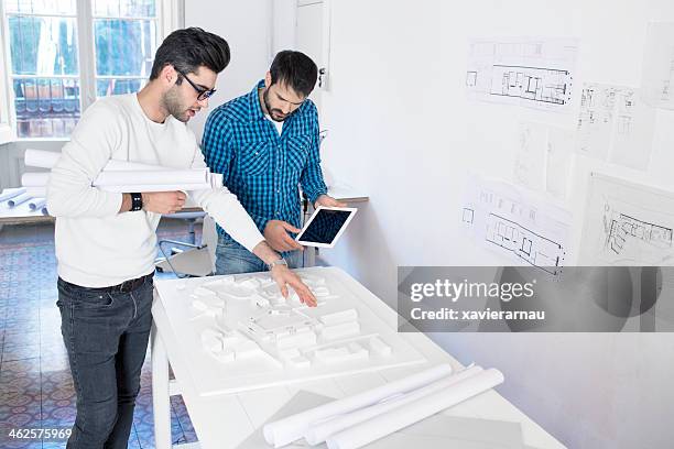 two men talking about the new building project. - construction consulting stock pictures, royalty-free photos & images