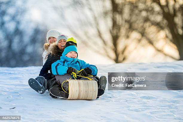 winter fun on tobbogan hill - fun snow stockfoto's en -beelden