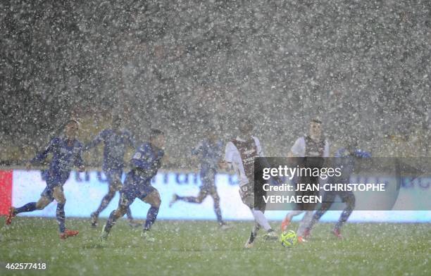 Sleet falls on the field during the French L1 football match between Metz and Nice at Saint Symphorien stadium in Metz, eastern France, on January...