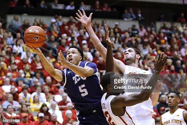 Kyan Anderson of the TCU Horned Frogs takes a shot as Dustin Hogue, and Georges Niang of the Iowa State Cyclones block in the second half of play at...