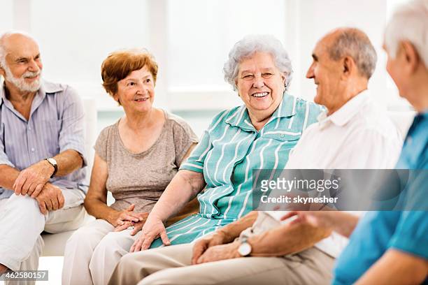 seniors communicating. - senior social gathering stock pictures, royalty-free photos & images