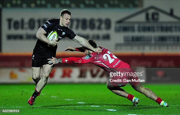 Eamonn Sheridan of London Irish makes a break past Kyle Evans of Scarlets during the LV= Cup match between Scarlets and London Irish at Parc y...