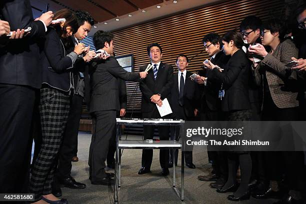 Japanese Prime Minister Shinzo Abe speaks to media reporters at his official residence on February 1, 2015 in Tokyo, Japan. The video purported to...