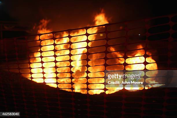 Mattresses and bed frames burn as Doctors Without Borders staff dismantle much of the Ebola Treatment Unit on January 31, 2015 in Paynesville,...