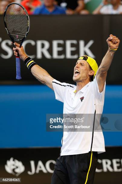 Andreas Seppi of Italy celebrates winning in his first round match against Lleyton Hewitt of Australia during day two of the 2014 Australian Open at...