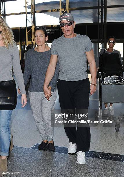 Jean-Claude Van Damme and Gladys Portugues are seen at LAX on January 31, 2015 in Los Angeles, California.