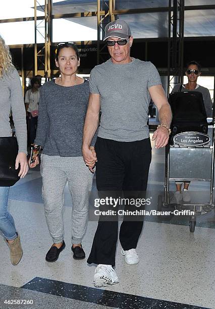 Jean-Claude Van Damme and Gladys Portugues are seen at LAX on January 31, 2015 in Los Angeles, California.