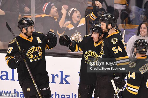 Patrice Bergeron, Brad Marchand and Adam McQuaid of the Boston Bruins celebrate a goal against the Los Angeles Kings at the TD Garden on January 31,...