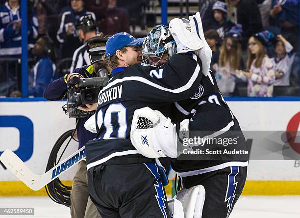 Goalie Evgeni Nabokov of the Tampa Bay Lightning congratulates teammate Ben Bishop on the win after the game against the Columbus Blue Jackets at the...