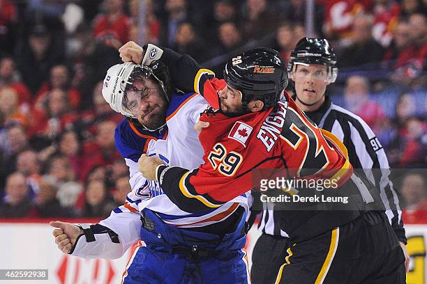 Deryk Engelland of the Calgary Flames fights Luke Gazdic of the Edmonton Oilers during an NHL game at Scotiabank Saddledome on January 31, 2015 in...