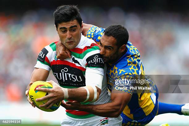 Bryson Goodwin of the Rabbitohs scores a try in the tackle of Reece Robinson of the Eels during the match between the Rabbitohs and the Eels in the...