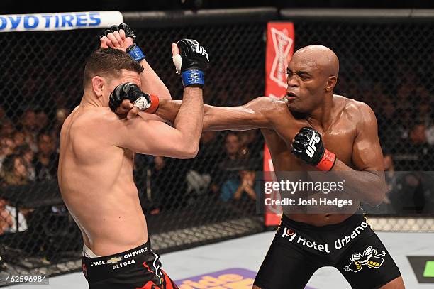 Anderson Silva punches Nick Diaz in their middleweight bout during the UFC 183 event at the MGM Grand Garden Arena on January 31, 2015 in Las Vegas,...