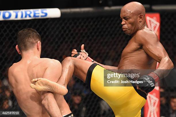 Anderson Silva kicks Nick Diaz in their middleweight bout during the UFC 183 event at the MGM Grand Garden Arena on January 31, 2015 in Las Vegas,...