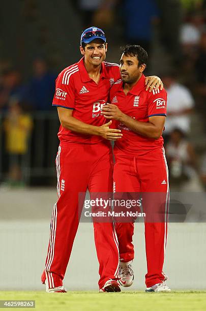 Ravi Bopara of England is congratulated by Alastair Cook after taking a wicket during the International tour match between the Prime Minister's XI...