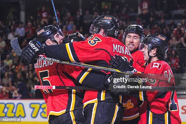 Mark Giordano congratulates Sean Monahan after he scored against the Edmonton Oilers during an NHL game at Scotiabank Saddledome on January 31, 2015...