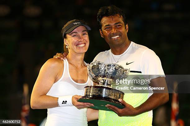Martina Hingis of Switzerland and Leander Paes of India hold the winners trophy after their final mixed doubles match against Kristina Mladenovic of...
