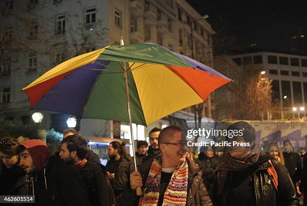 Demonstrator holds an umbrella in the colours of the rainbow flag.A huge demonstration was organised in Athens against the planned demonstration of...