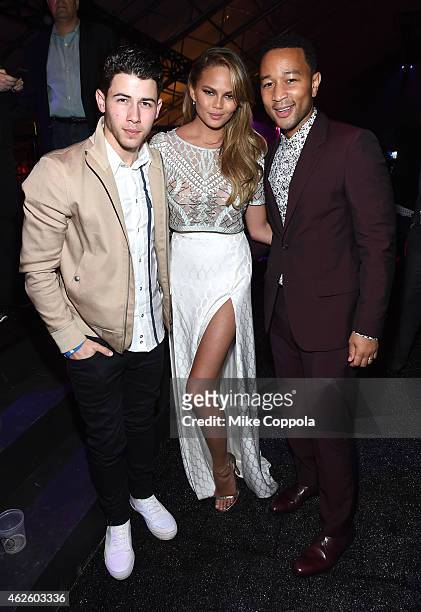 Recording artist Nick Jonas, model Chrissy Teigen and recording artist John Legend attend DirecTV Super Saturday Night hosted by Mark Cuban's AXS TV...