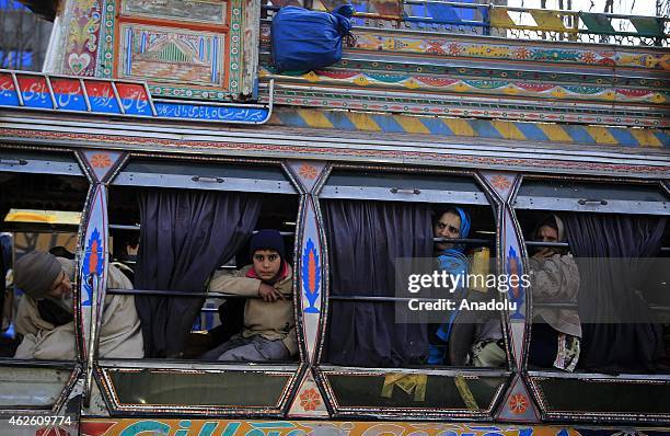 People traveling with a bus are seen in Muzaffarabad the capital of Pakistan-administered Azad Jammu and Kashmir on January 27, 2015. Almost 4...