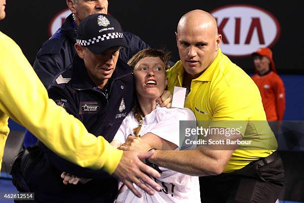 Protestor is carried from centre court at Rod Laver Arena during day 14 of the 2015 Australian Open at Melbourne Park on February 1, 2015 in...
