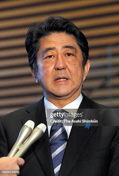 Japanese Prime Minister Shinzo Abe speaks to media reporters at his official residence on February 1, 2015 in Tokyo, Japan. The government's...