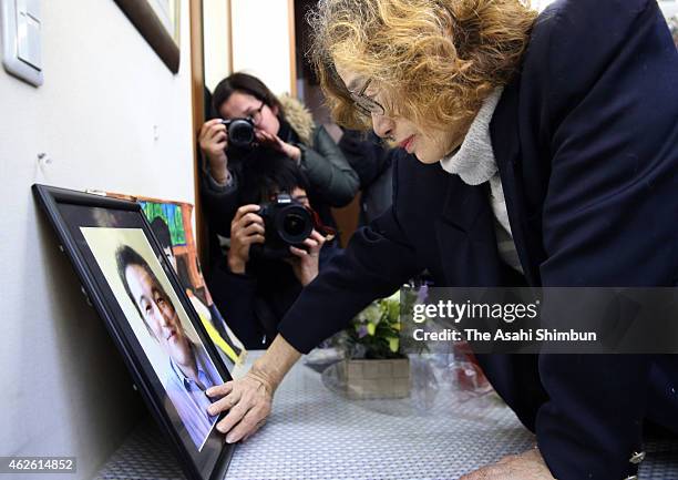 Junko Ishido, the mother of Japanese hostage Kenji Goto, touches her son's portrait, after a new video of his son was posted on February 1, 2015 in...