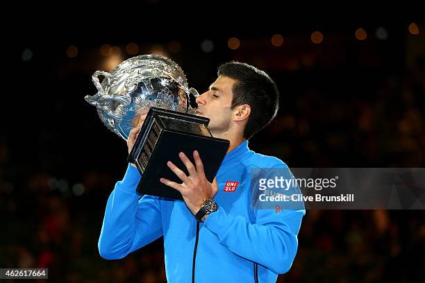 Novak Djokovic of Serbia kisses the Norman Brookes Challenge Cup after winning his men's final match against Andy Murray of Great Britain during day...