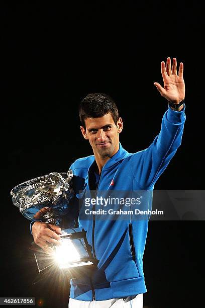 Novak Djokovic of Serbia holds the Norman Brookes Challenge Cup after winning his men's final match against Andy Murray of Great Britain during day...