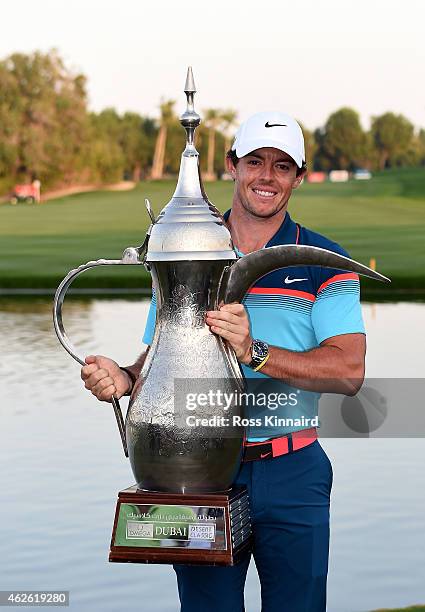 Rory McIlroy of Northern Ireland with the winners trophy after the final round of the Omega Dubai Desert Classic at the Emirates Golf Club on...