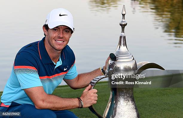 Rory McIlroy of Northern Ireland with the winners trophy after the final round of the Omega Dubai Desert Classic at the Emirates Golf Club on...